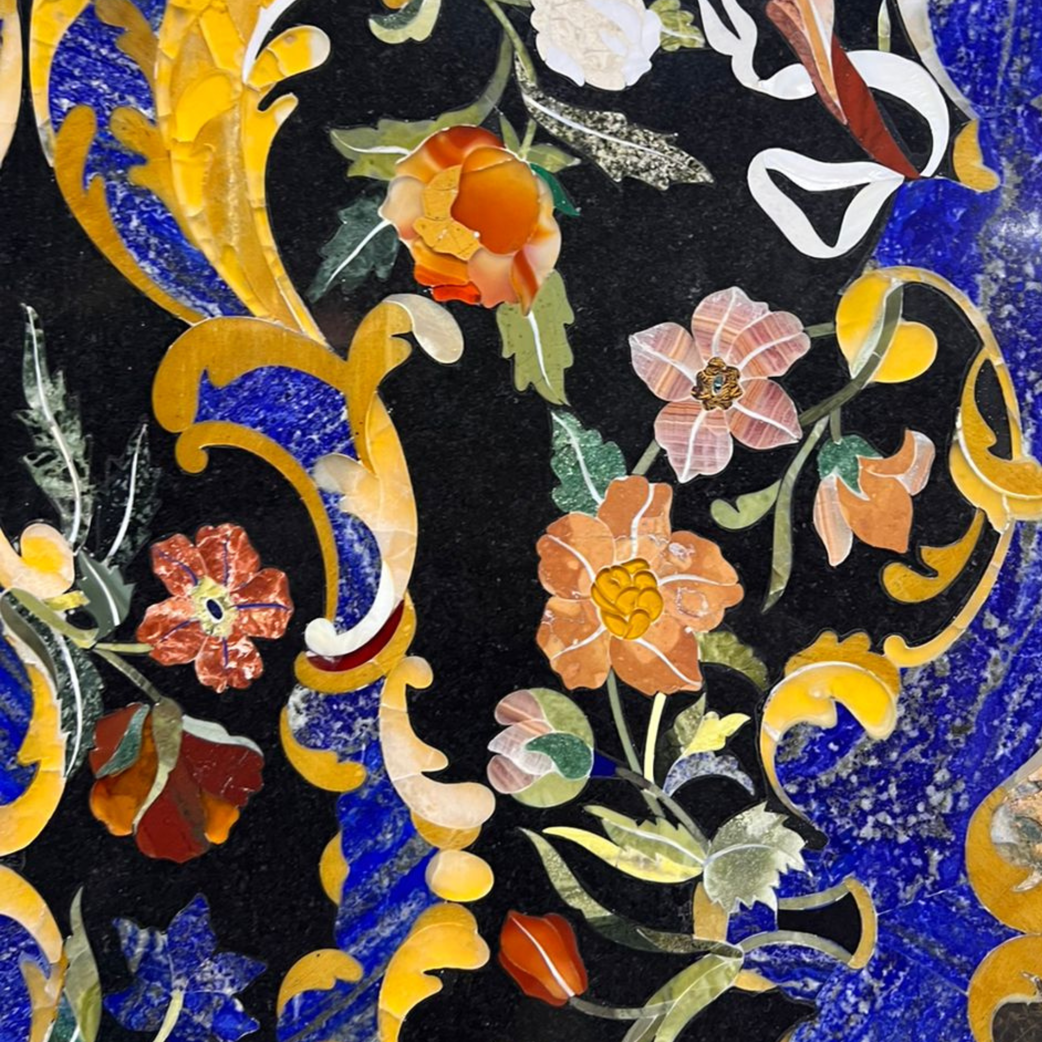 Semi-precious stone inlay table top features intricate pietra dura craftsmanship