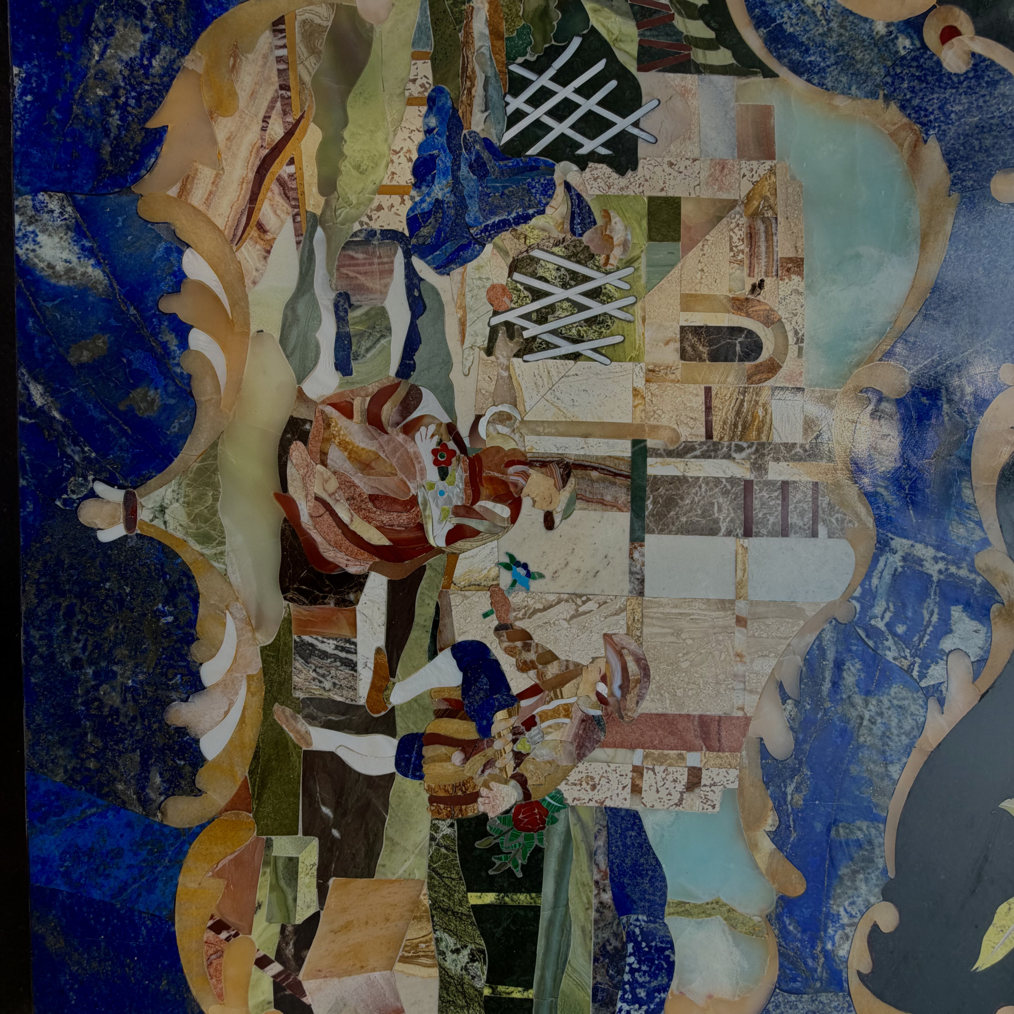 Semi-precious stone inlay table top features intricate pietra dura craftsmanship