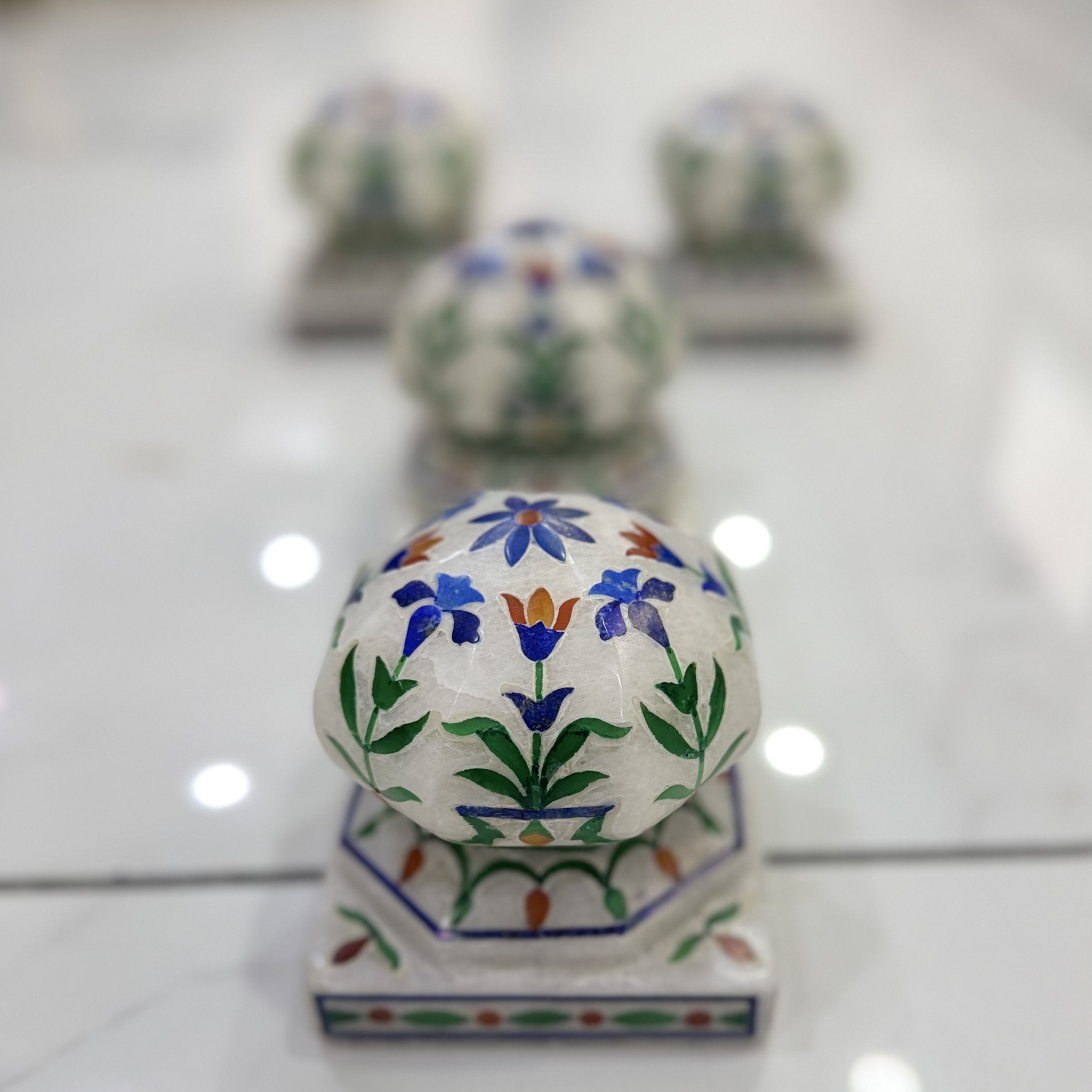 Marble carpet weight, inlaid with semi-precious stones | master of the carpet