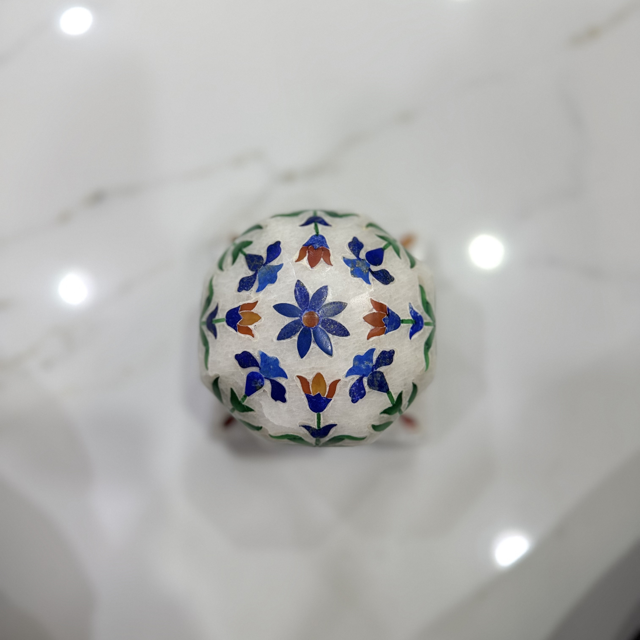 Marble carpet weight, inlaid with semi-precious stones | master of the carpet